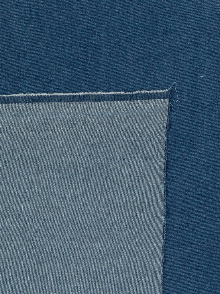 Overhead flat shot of Workwear Blue Cotton Denim, revealing its yarn-dyed indigo surface, balanced natural reverse, and authentic workwear-inspired texture with clean twill definition.