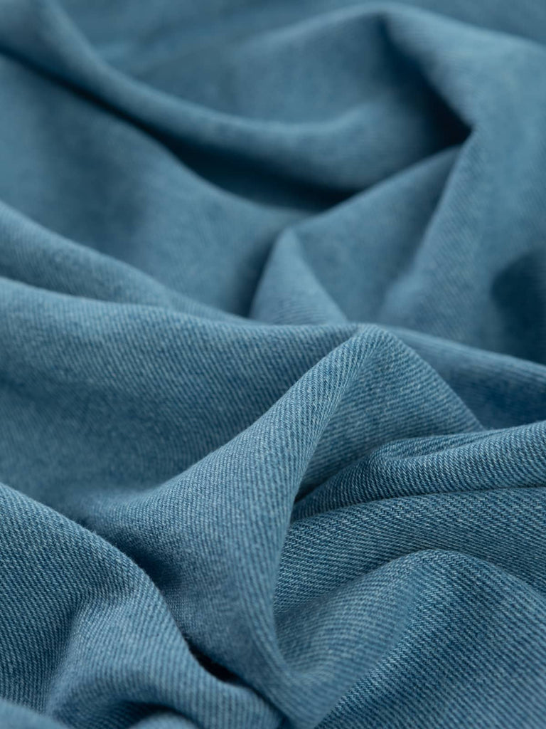 Twist of Summer Skies 100% Cotton Denim, 330gsm, showing soft pale blue face with natural cotton reverse and subtle diagonal twill lines highlighting its authentic denim weave.