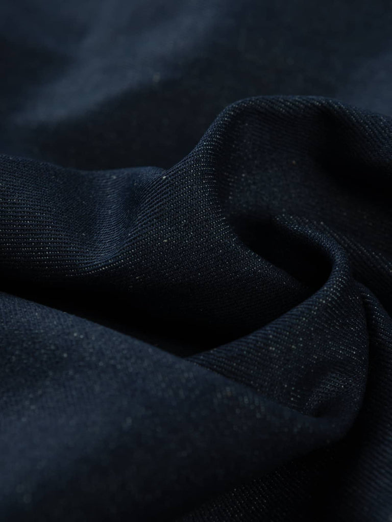 Twist of Midnight Indigo 100% Cotton Denim, 470gsm, showing deep inky navy face with natural cotton reverse, strong twill lines, and firm, structured texture reflecting its heavyweight quality.