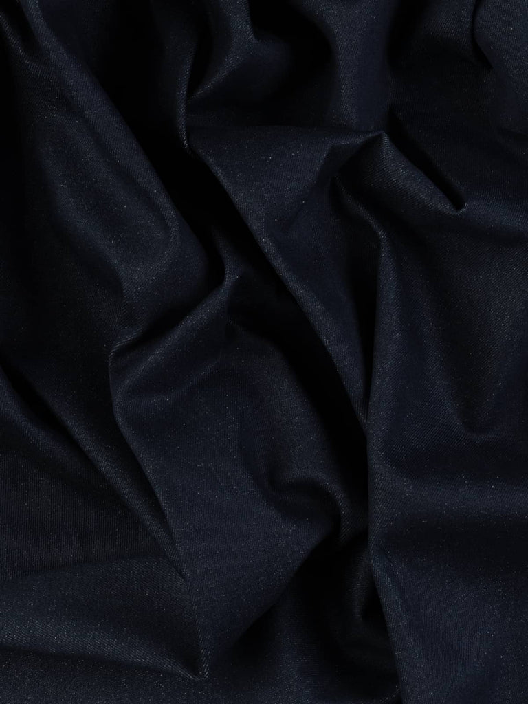 Overhead shot of Midnight Indigo Denim fabric, capturing its refined workwear-inspired surface, deep indigo-blue hue, and crisp structured finish with classic twill grain detail.