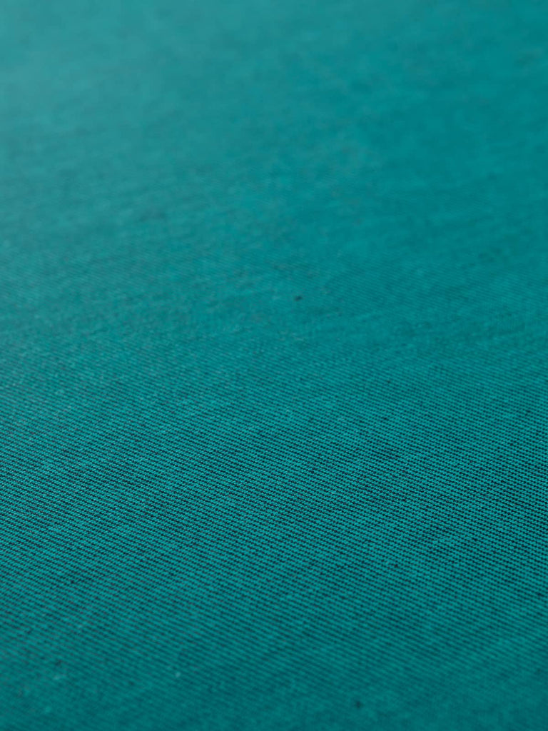 Angled flat view of Teal Shot Denim, 166cm wide, revealing the inky navy face with subtle teal undertones, enhanced by the smooth twill weave and shot-effect lustre.