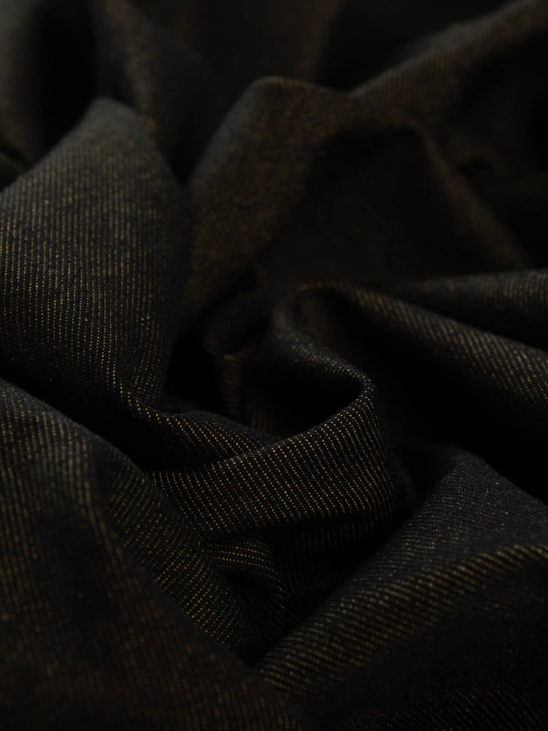Angled flat view of Mustard Shot Denim, 166cm wide, revealing the black face with subtle diagonal weave and warm mustard reverse for a striking contrast of tone and texture.