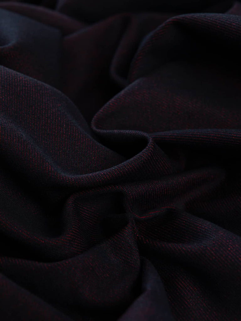 Twist of Raspberry Shot 100% Cotton Denim, 370gsm, showing deep indigo-blue face interwoven with vivid raspberry-pink undertones, highlighting its reversible two-tone weave and crisp twill texture.