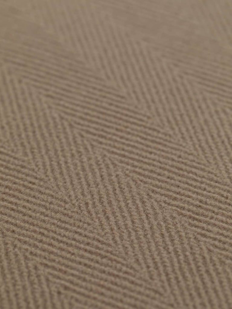 A close-up view of heavyweight wool fabric in a sophisticated sandy beige hue, featuring a 6cm chevron pattern. Ideal for creating timeless overcoats, jackets, and elegant ensembles, this versatile fabric blends classic style with durability.