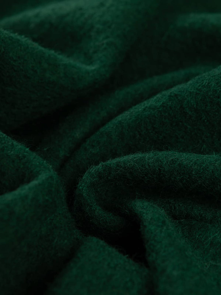 Twist of Woodland Green 100% Boiled Wool Knit, 410gsm, showing dense felted texture and rich mossy green hue with soft boucle surface and supple, structured drape.