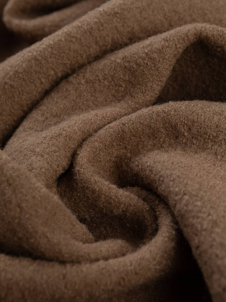 Twist of Soft Brown 100% Boiled Wool Knit, 410gsm, showing dense, felted texture and warm milky-coffee hue with subtle boucle detailing and softly structured drape.