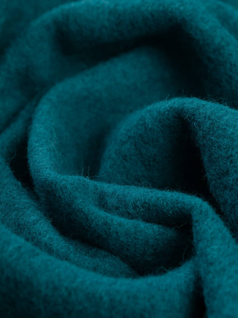 Twist of Turquoise Gem 100% Boiled Wool Knit, 410gsm, showing its dense felted texture and radiant turquoise-blue green tone inspired by Mediterranean waters and natural gemstones.