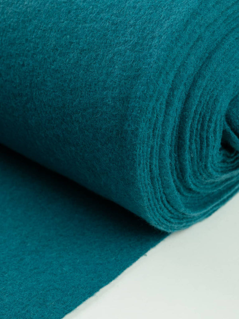 Turquoise Gem Wool Knit, capturing the smooth, felted boiled wool texture and luminous turquoise hue that blends clarity, warmth, and modern refinement.