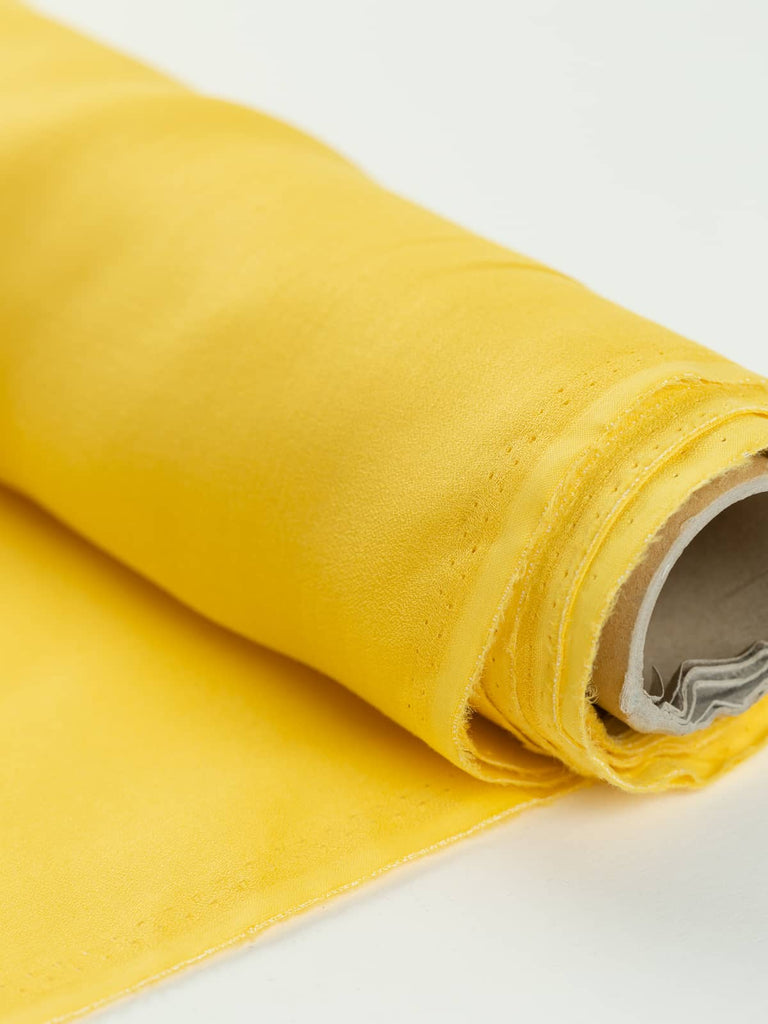 Bright yellow crepe fabric lightweight for sewing clothing