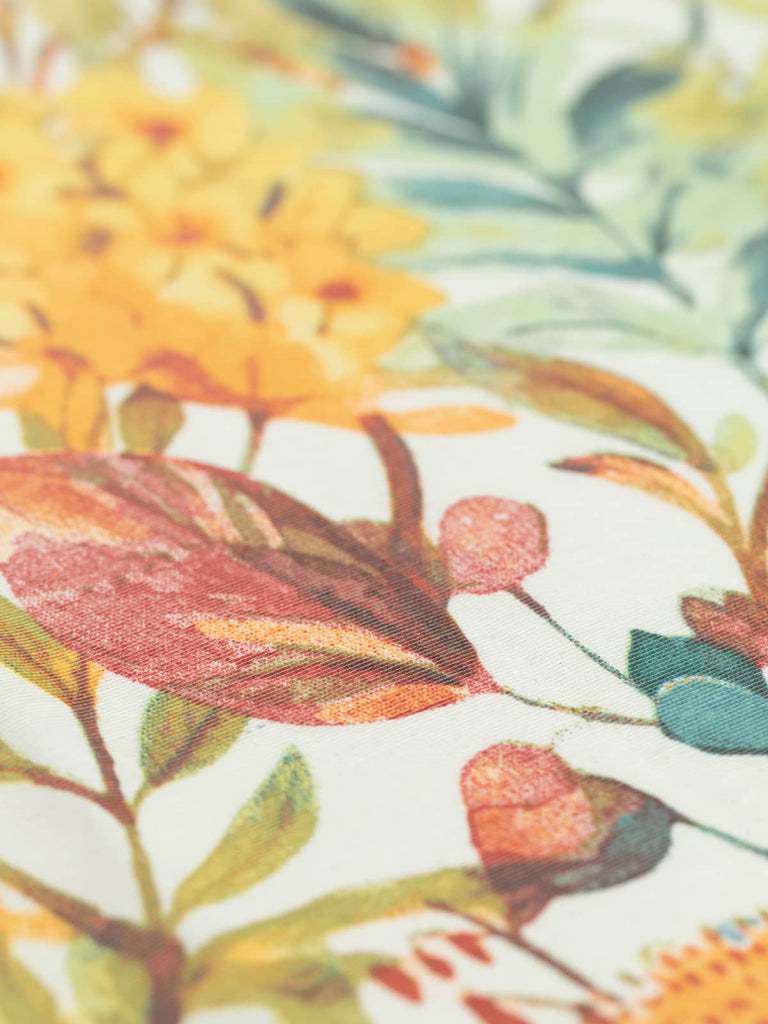 This waterproof outdoor fabric, Fire Meadow, showcases a beautiful botanical design with warm hues on a cream background. Ideal for garden furniture, sun canopies, and wipeable bags, it combines durability with a stylish and elegant aesthetic.