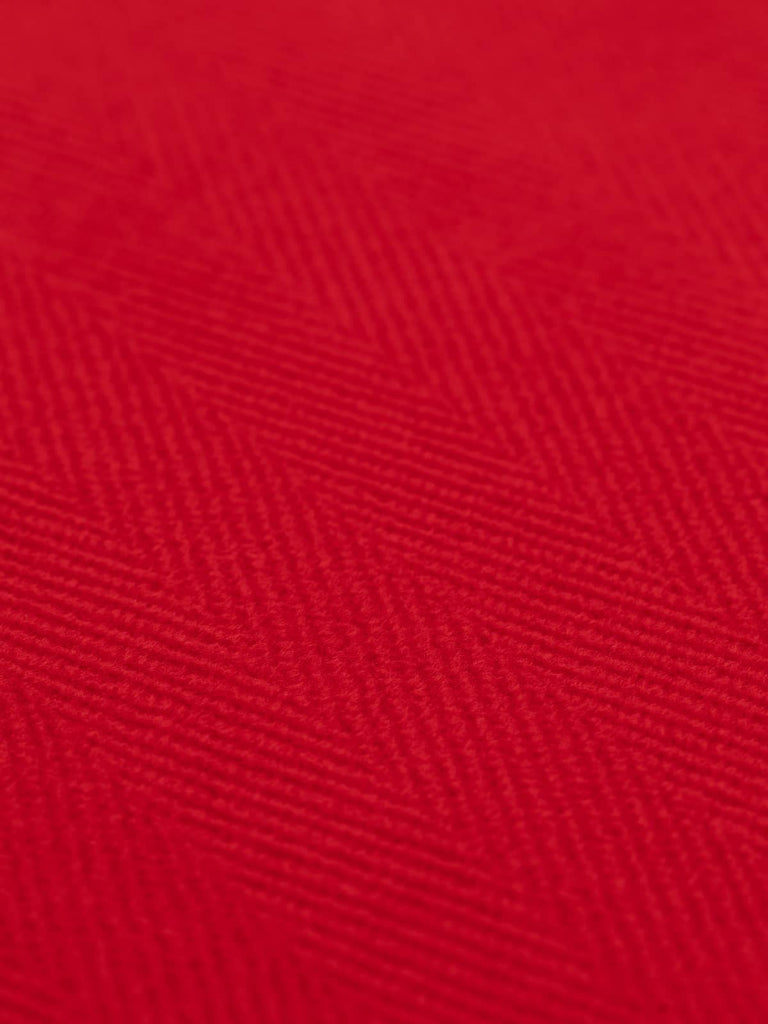 Close-up of a scarlet red jumbo herringbone wool coating, featuring bold 6cm wide chevron patterns. This double-faced, Italian wool fabric is ideal for crafting heavy overcoats, military uniforms, or upholstery projects, offering a soft yet sturdy texture.