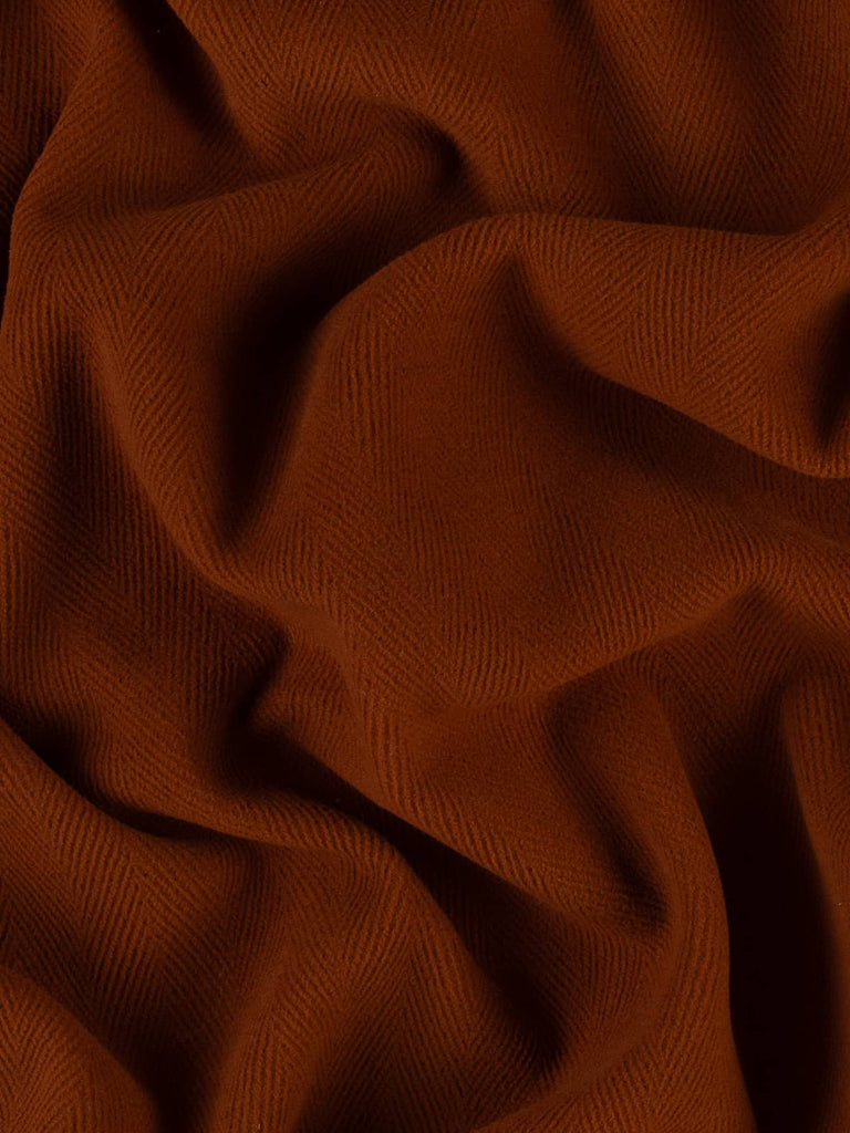 Image of a rich orange-brown wool fabric showcasing a bold 6cm chevron design. This dense, felted fabric is ideal for crafting winter garments, field jackets, or adding a splash of color to upholstery projects.