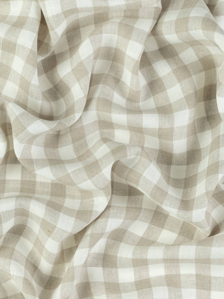 From above, the twisted fabric shows a soft and airy drape, with beige and white checks forming a subtle grid. The lightweight linen catches the light delicately, hinting at its breathability and summer-friendly nature.