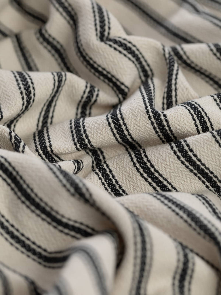 Classic chic ticking fabric popular choice for curtains, blinds and upholstery. 100% cotton fabric. contemporary interior design textiles. hard-wearing durable, 30000 rub count martindale test. Repeatable restockable regular stock item. £30 per metre. Standard width furnishing fabric. Made in Europe EU. Vintage look, brand new fabric. Herringbone weave. Choice of colours – blue green grey pink with natural ecru neutral cream tones.