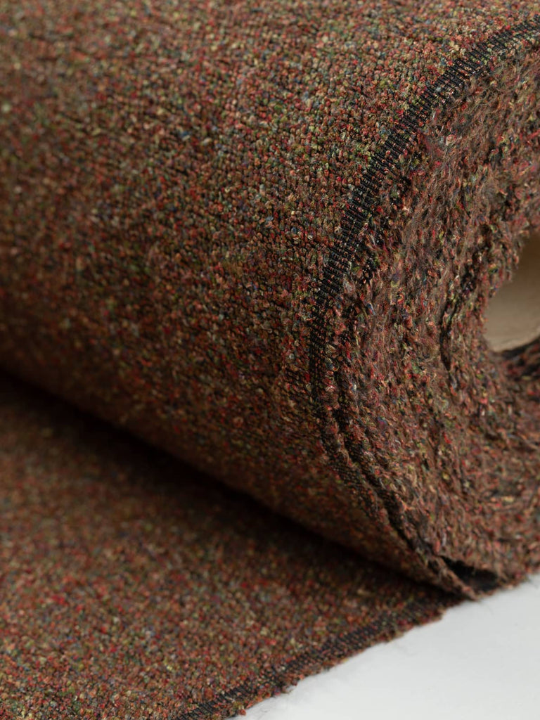 Heavyweight boucle fabric for furnishing & upholstery. Marled multiple colours green red brown orange yellow melange colourway. Available to buy for home furnishing projects.