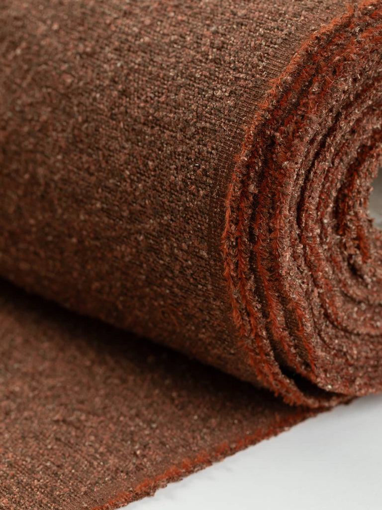 Heavyweight boucle fabric for furnishing & upholstery. Marled orange russet rust terracotta colourway. Available to buy for home furnishing projects.